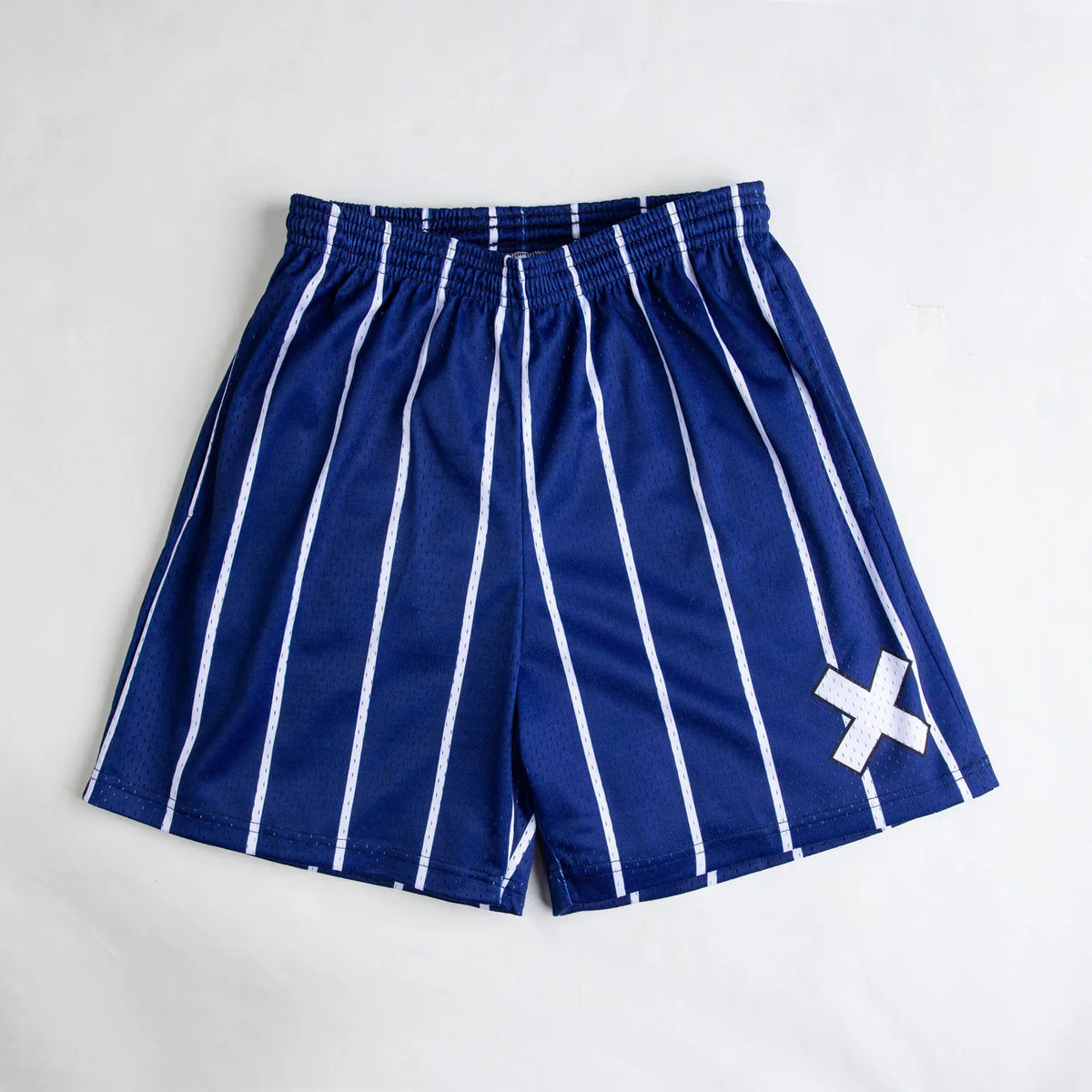 Blue shorts with white stripes and a white 'X' on a light gray background
