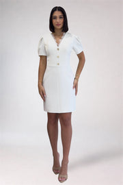 Woman wearing a white dress with buttons on a white background