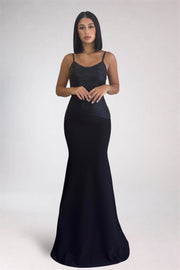 Woman wearing a black evening gown on a white background