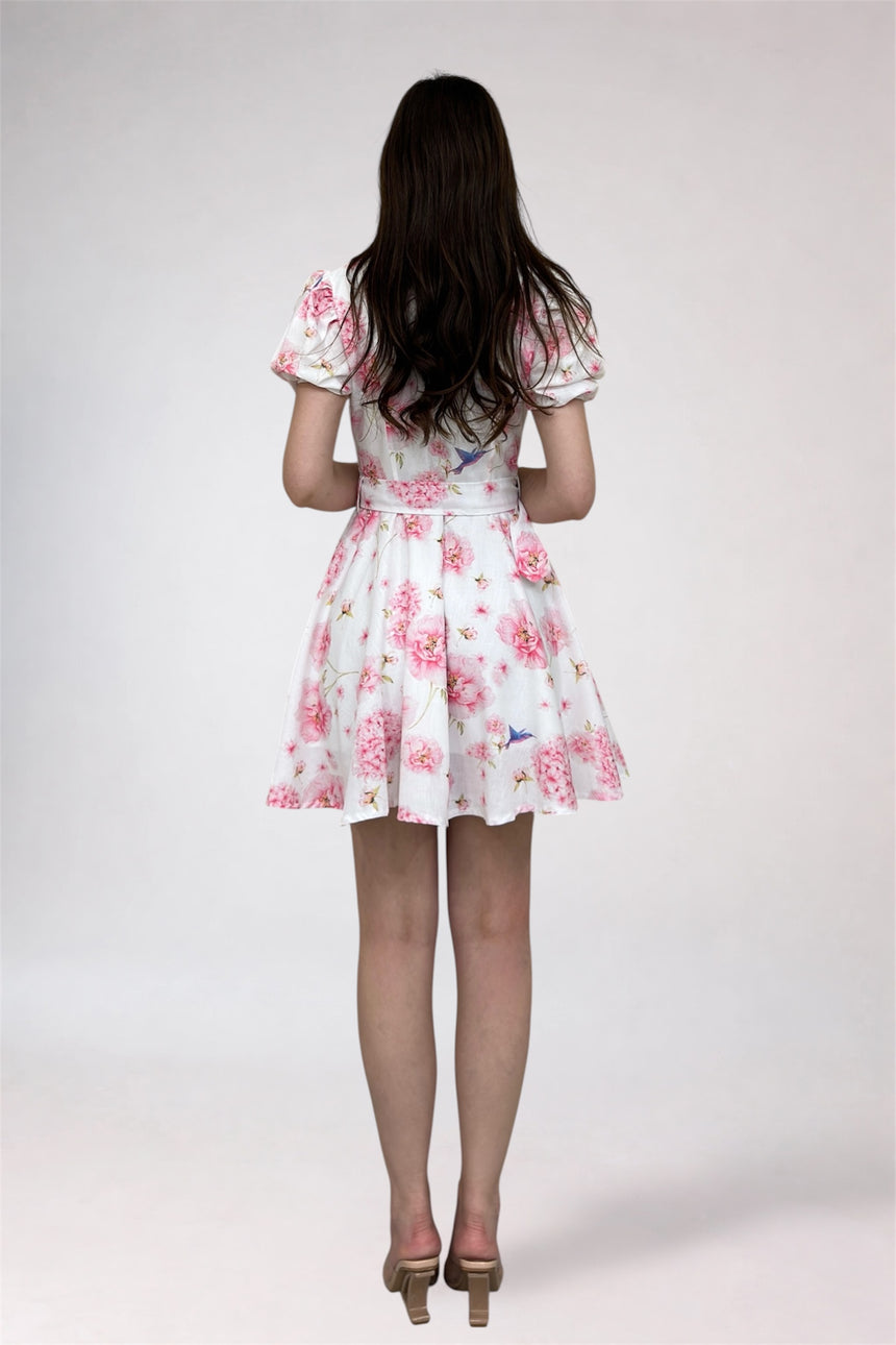 Woman wearing a floral dress on a plain background