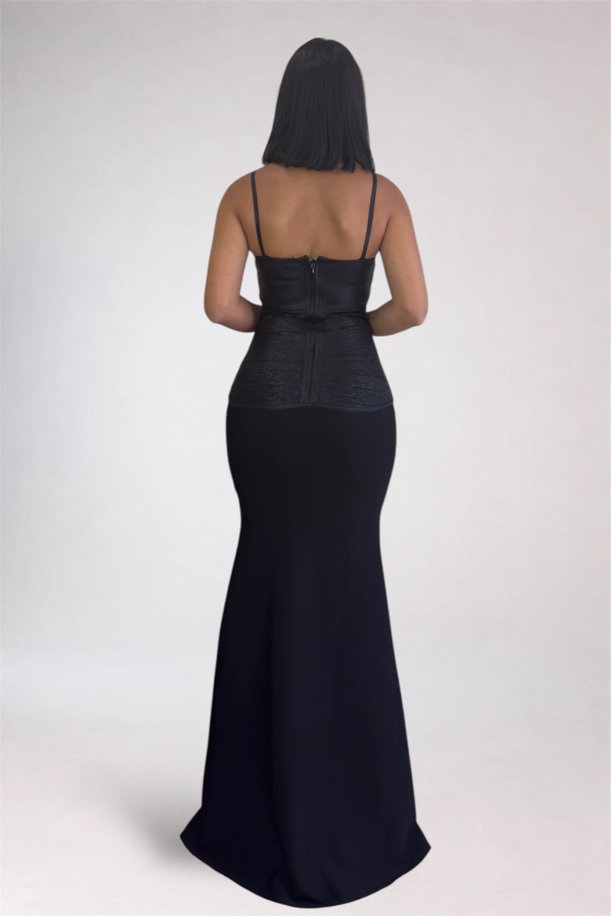 Black evening gown with a fitted silhouette on a white background