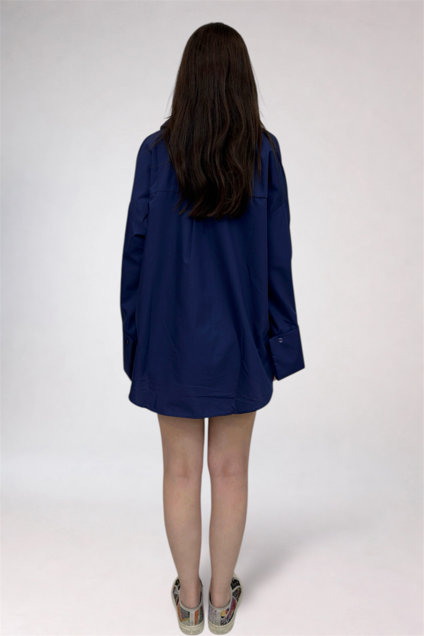 Person wearing a blue jacket on a white background