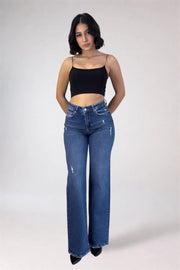 Woman wearing blue jeans and a black top on a white background