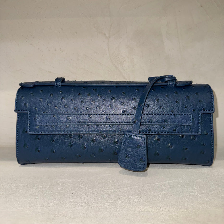 Blue textured handbag on a light gray background