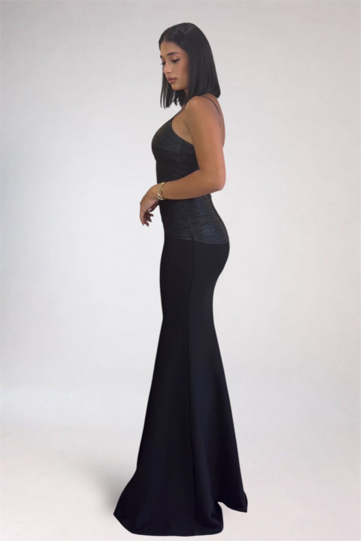 Woman wearing a black evening gown on a white background