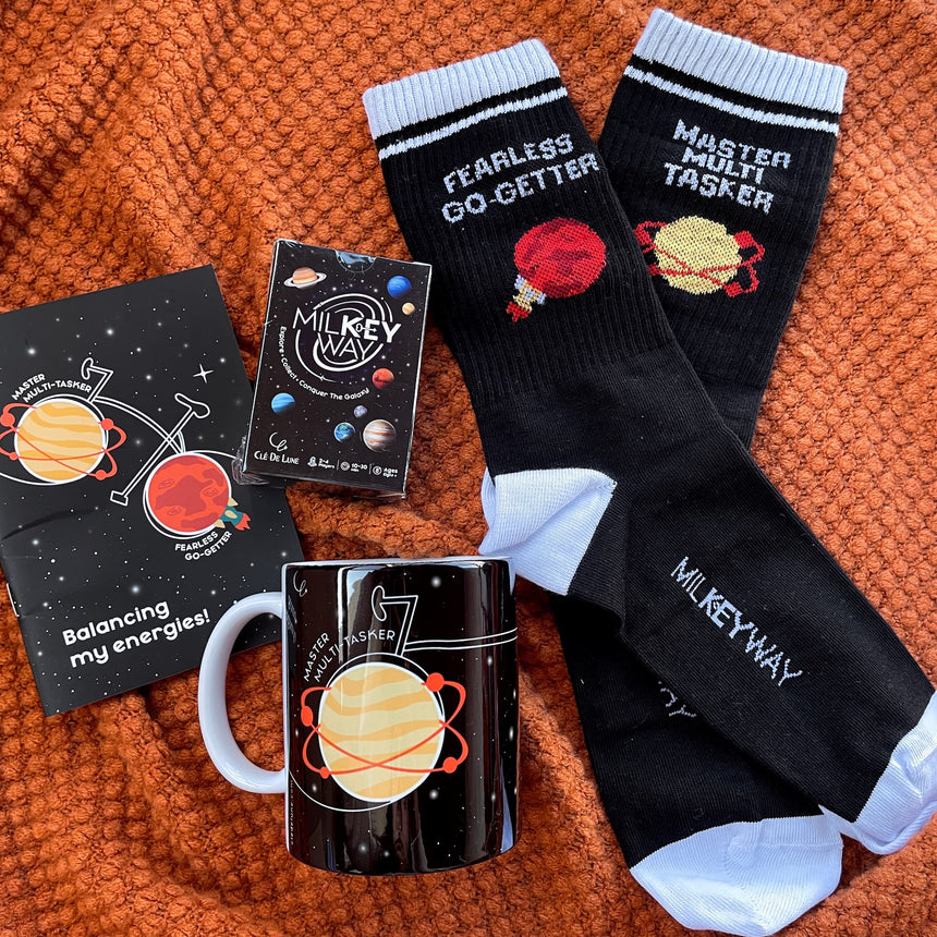 Venus & Mars Set - 1 Game, 1 Pair of Socks (Women Size), 1 Mug, 1 Notebook
