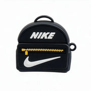 A black backpack-shaped Airpods 4 Case featuring a white Nike swoosh, white Nike logo text, and a yellow zipper detail, shown on a plain white background.