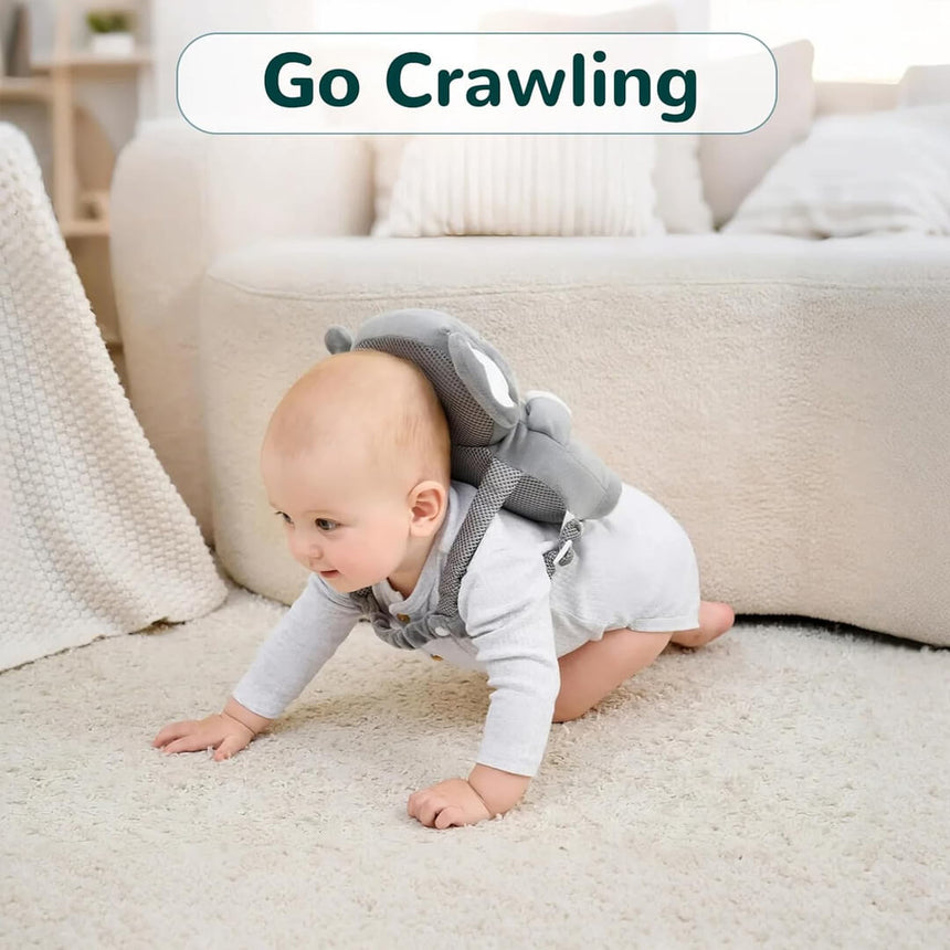 Baby crawling and wearing a grey koala safety head protector