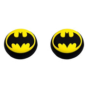 Two Batman logo earrings on a white background