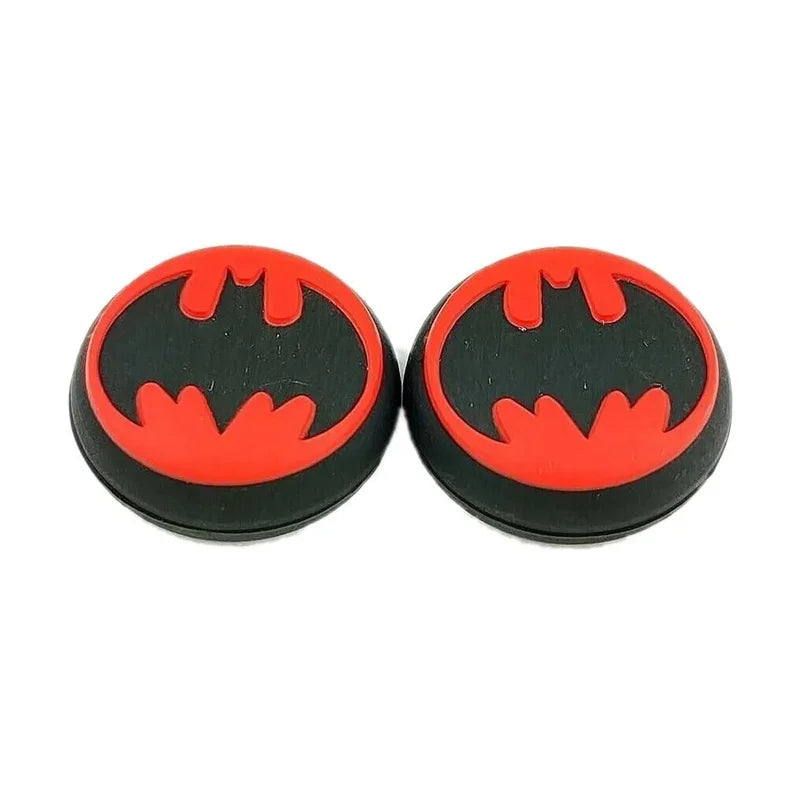 Two round black and red objects with a bat symbol on a white background