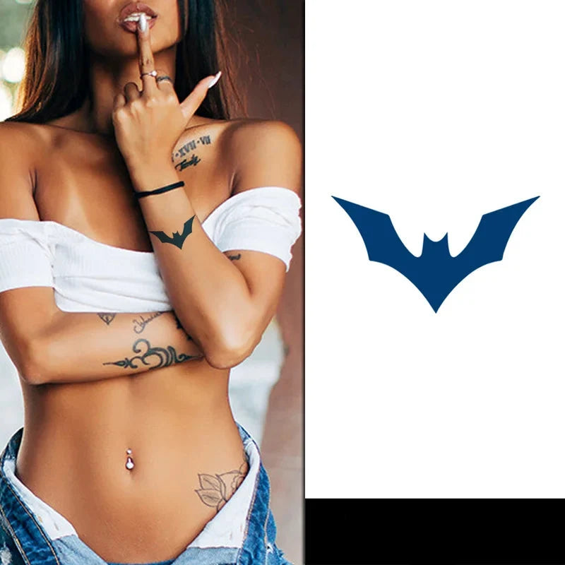 Woman with tattoos on her arm and chest, wearing a white top and denim shorts, with a Batgirl logo and 'SPX-062' text on a white background.