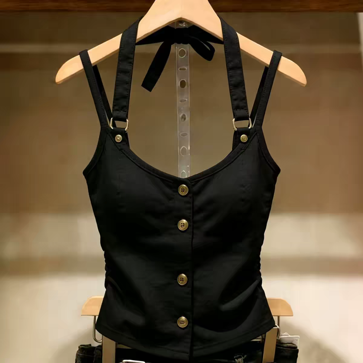 Black high quality fitted halter top with gold buttons on wooden hanger, size XL
