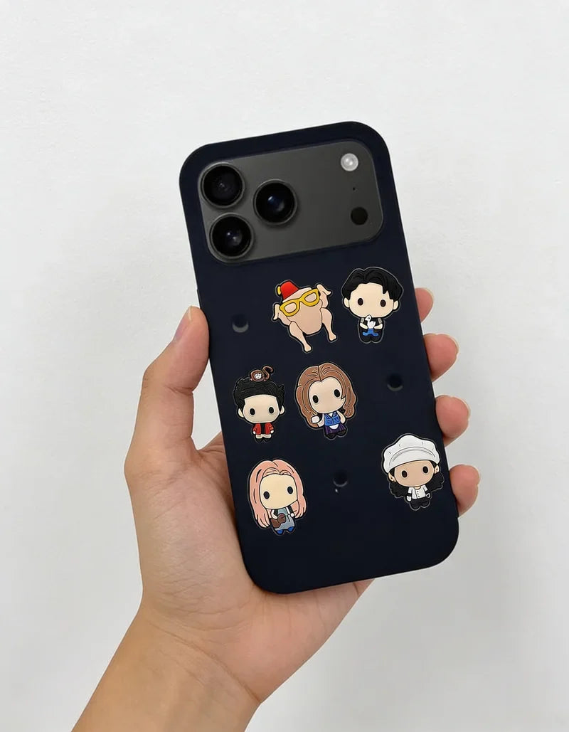 Phone case with cartoon character designs held by a hand on a light gray background