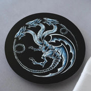 Decorative coaster with dragon design on a gray surface