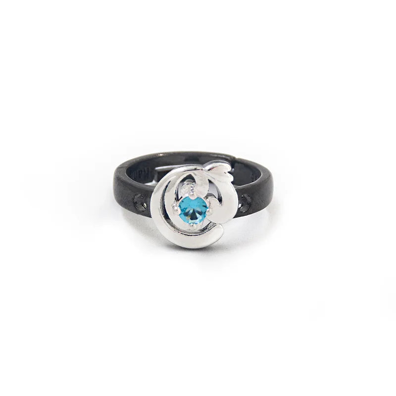 Ring with black band and silver design featuring a blue gemstone on a white background