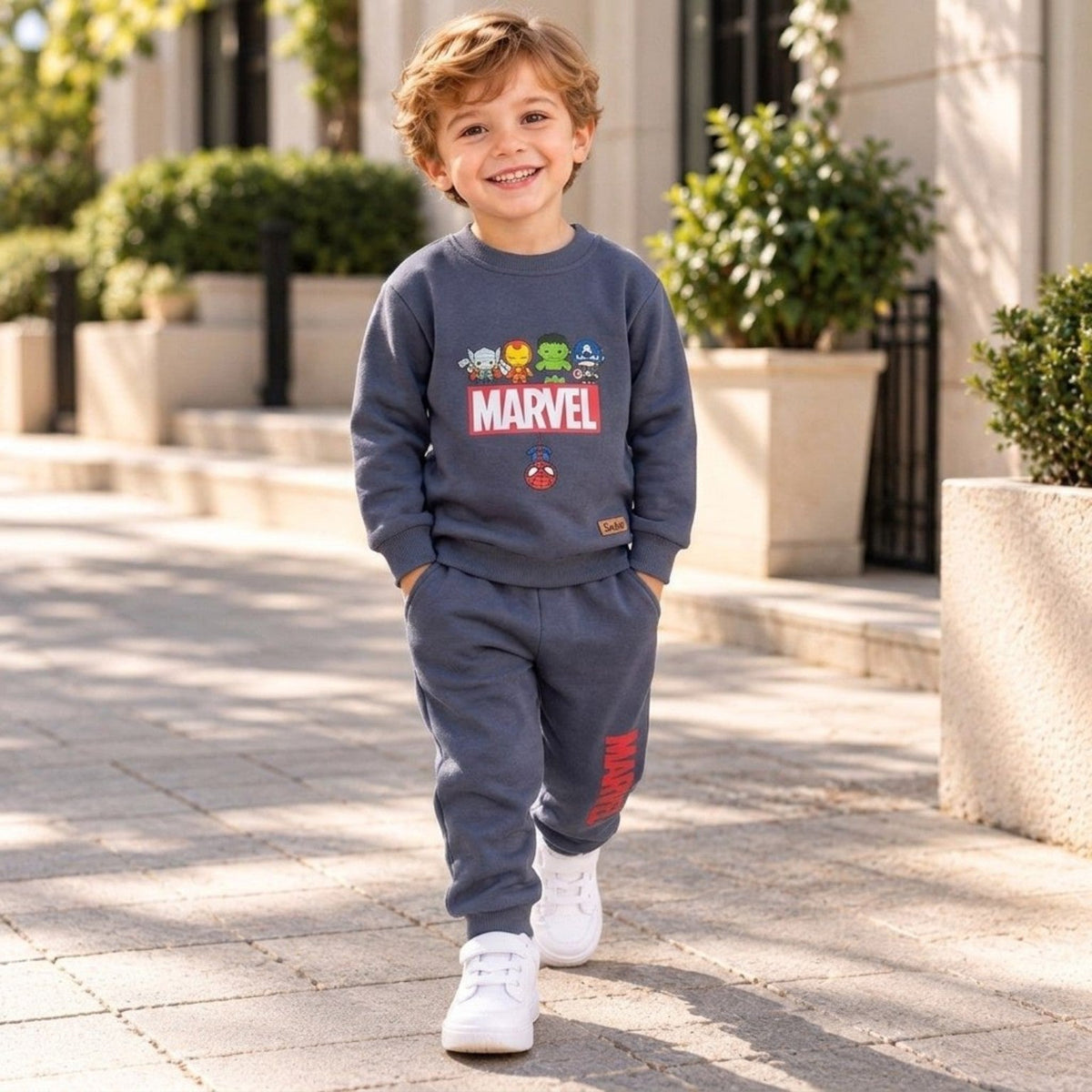 Boy wearing blue grey Marvel superheroes two-piece fleece outfit with matching joggers