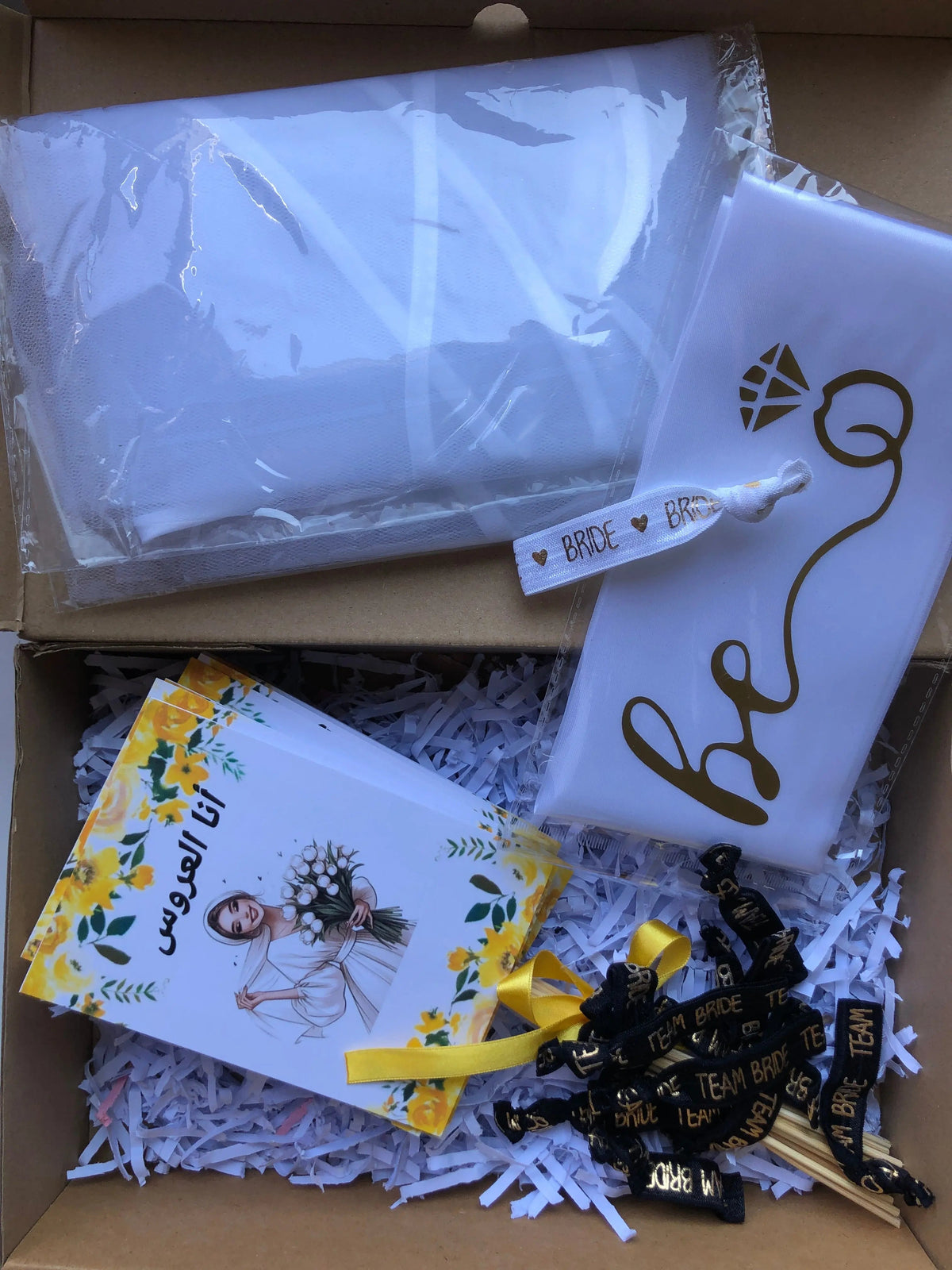 Bride To Be Box with props, bracelets, and decorative items
