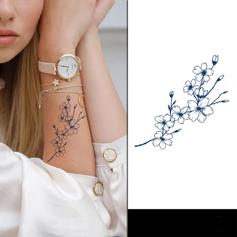 Woman's arm with floral tattoo and watch, close-up of tattoo design
