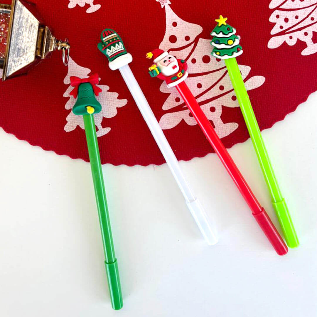 Four Christmas-themed gel pens: santa, tree, bell and gloves designs