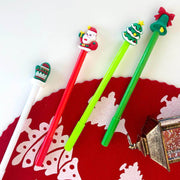 Four colorful pens with Christmas-themed tips