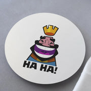 Round white coaster with a colorful illustration of a character wearing a crown and rainbow outfit, with 'HA HA!' text on a gray background.