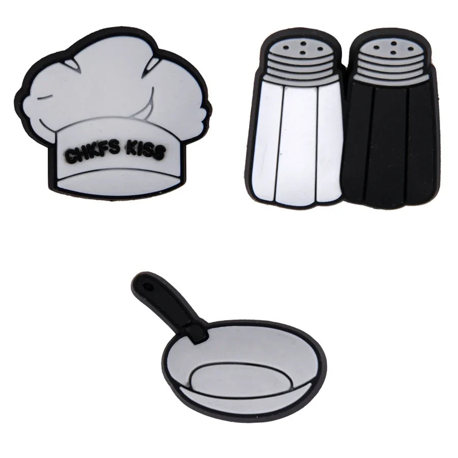 Set of kitchen-themed coasters including a chef's hat, salt and pepper shakers, and a frying pan on a white background.