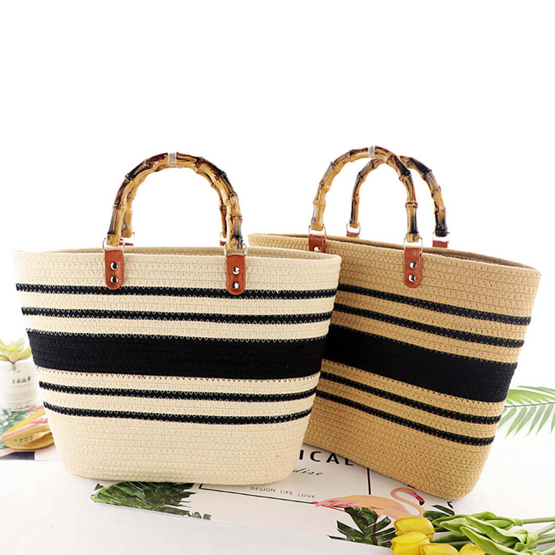 Two straw bags with black stripes and bamboo handles 