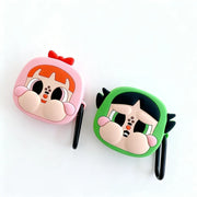 Two cartoon character-themed airpod cases, one pink and one green, on a white background.
