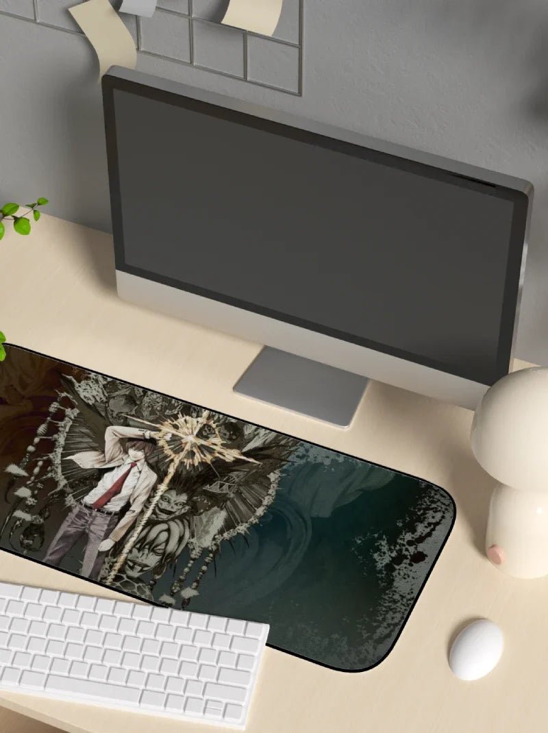 Desk setup with a computer monitor, keyboard, and decorative mouse pad.