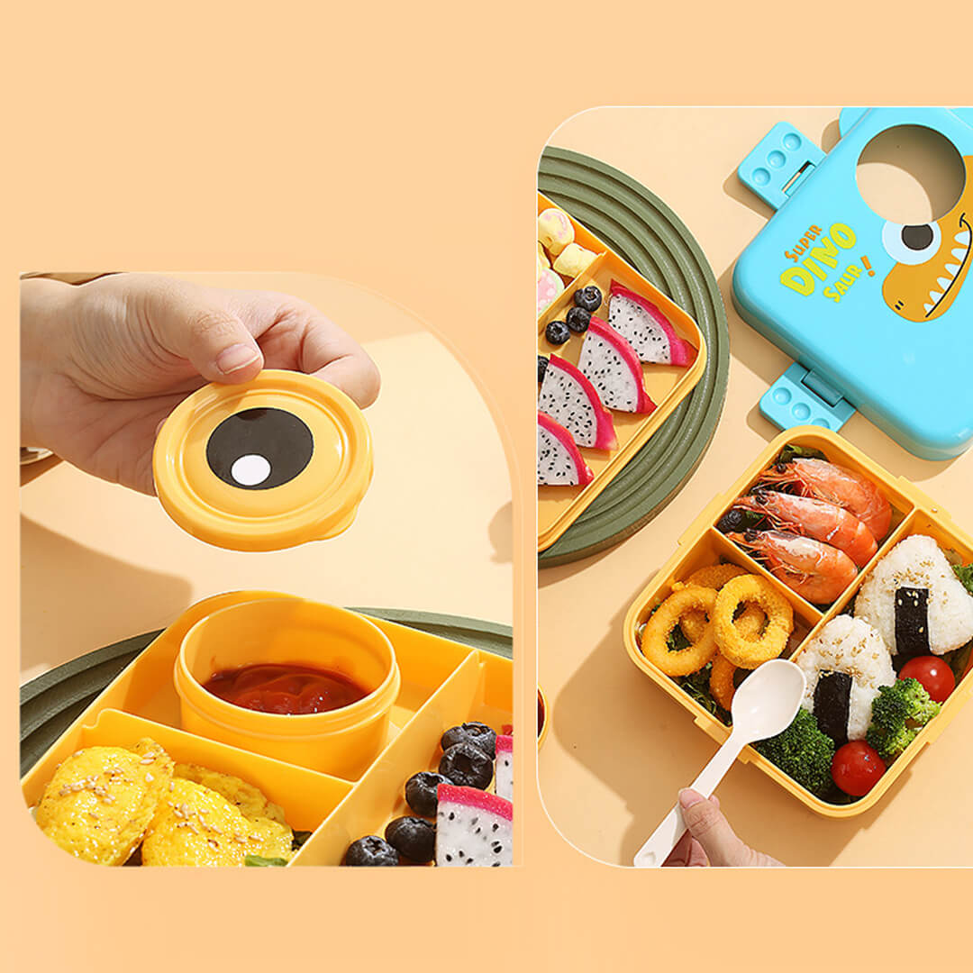 Children's bento box with a cute dino design with compartments filled with food 
