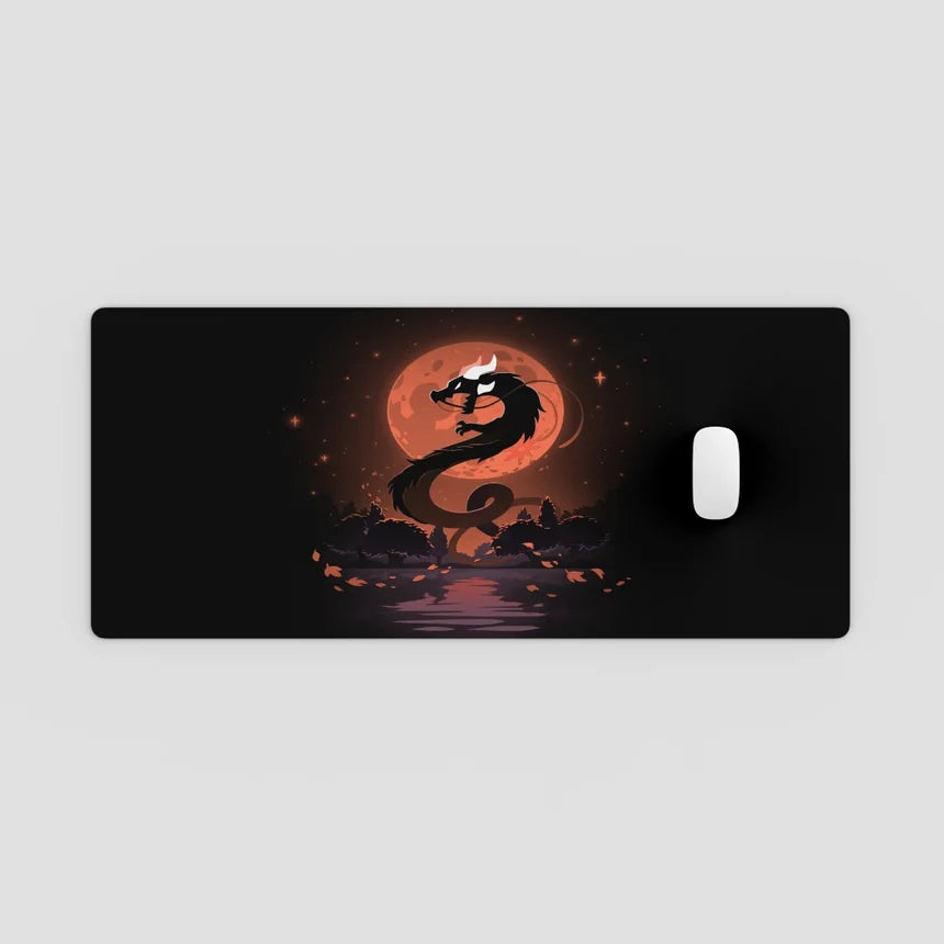 Dragon design on a black mouse pad with a red moon in the background