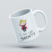White mug with a cartoon character and text 'I AM NOT SHORT!' on a light gray background