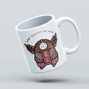 White mug with a cartoon character design on a light gray background