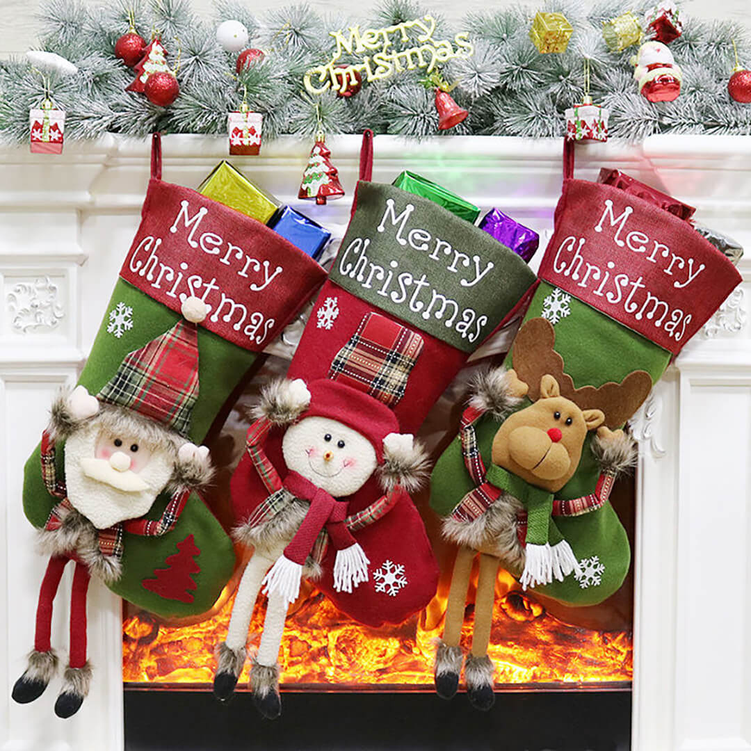 Three 3D Christmas stockings with festive designs hanging above a fireplace.