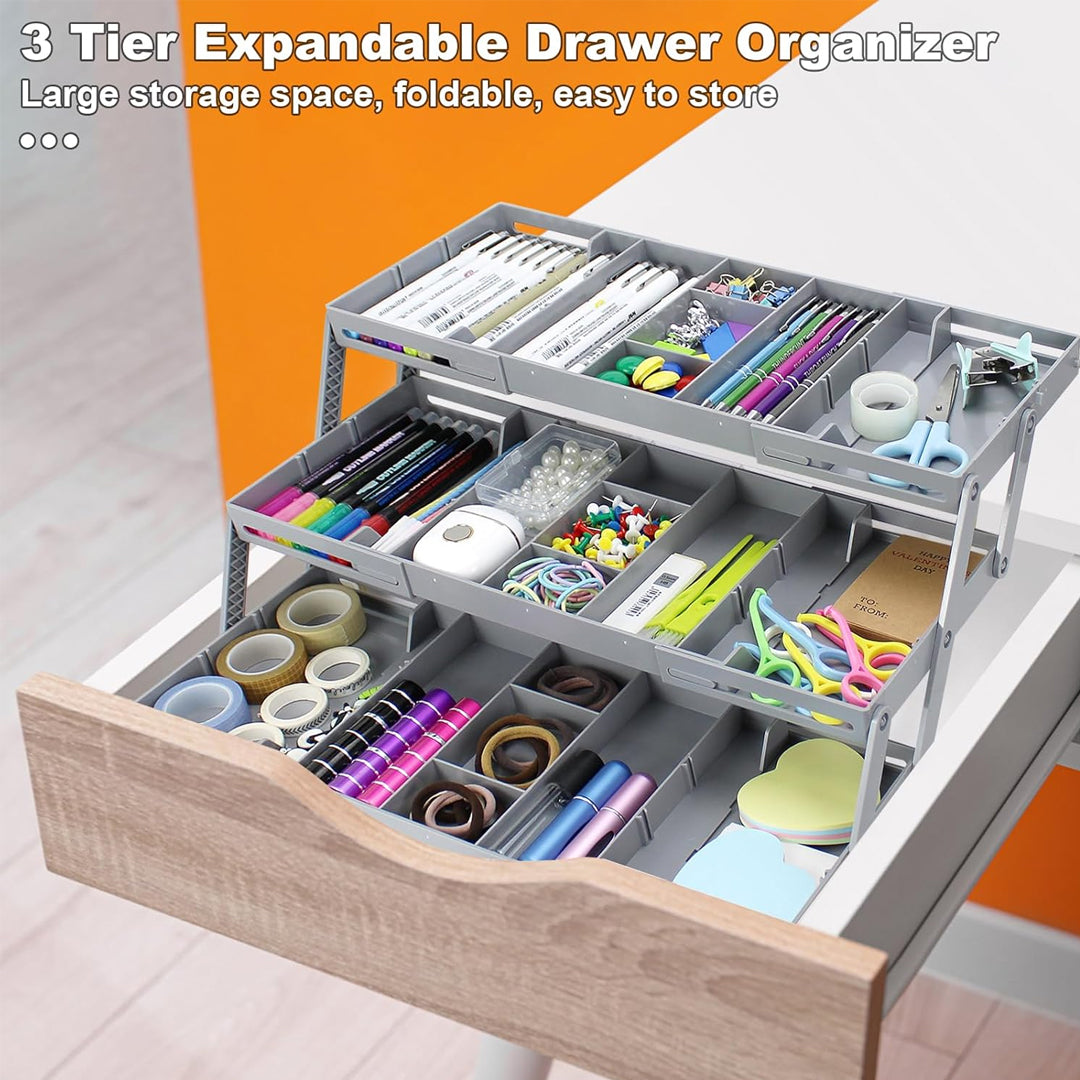 Three-tier expandable drawer organizer with stationery items inside an opened drawer