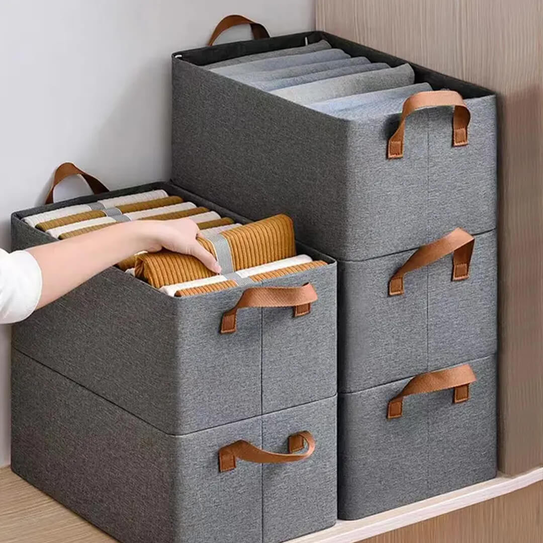 Stack of collapsible storage boxes for closet organization, grey color
