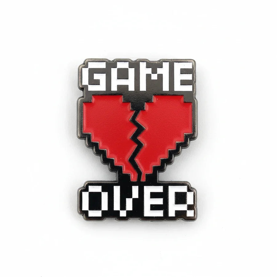 Pixelated 'GAME OVER' heart-shaped enamel pin on a white background
