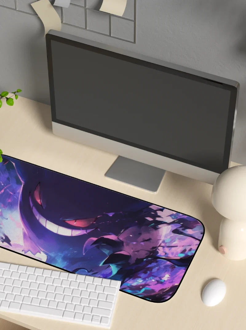 Desk setup with a computer monitor, keyboard, and mouse on a desk with a large mouse pad featuring a colorful design.