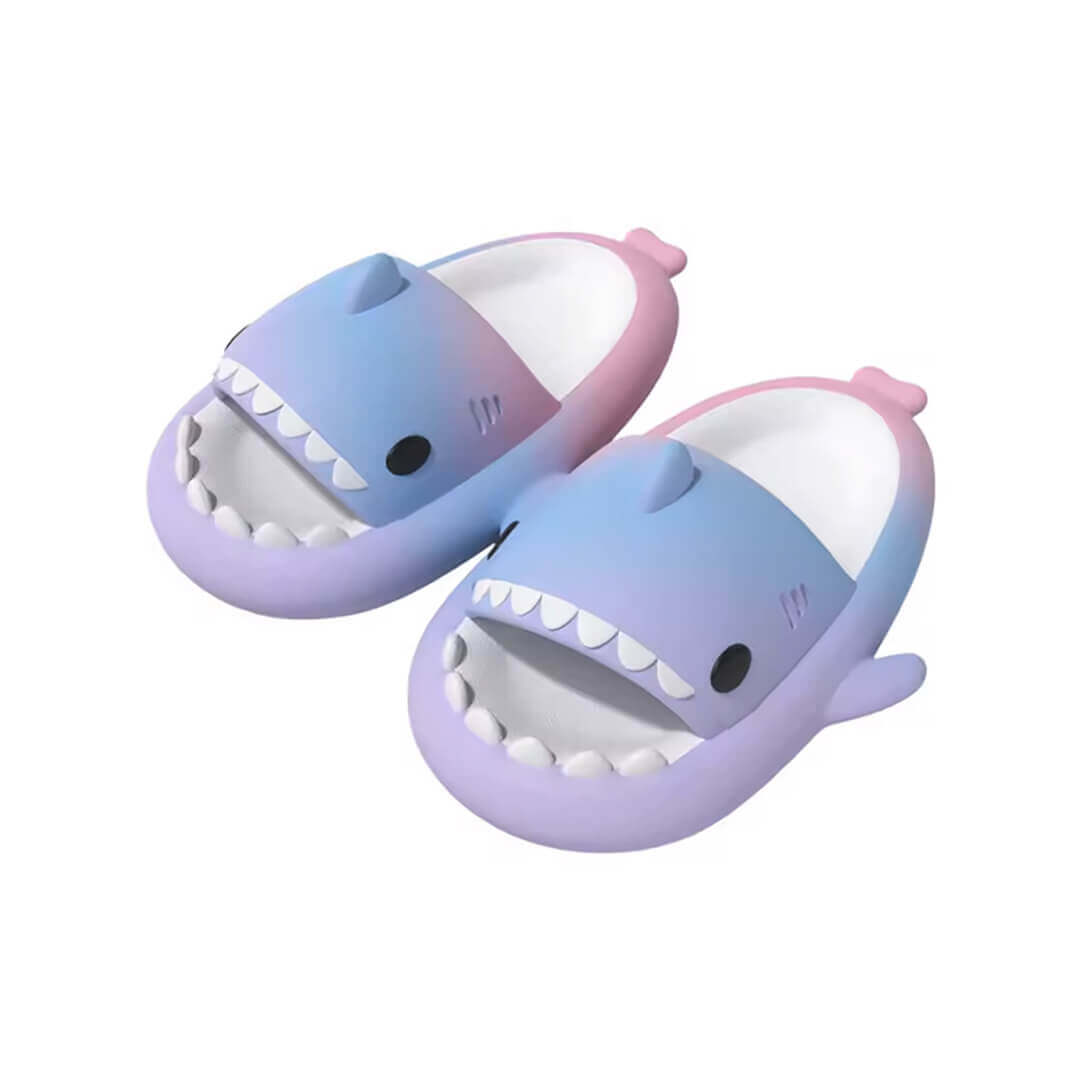 A pair of shark-shaped slippers for girls with a gradient color pink, blue, and purple
