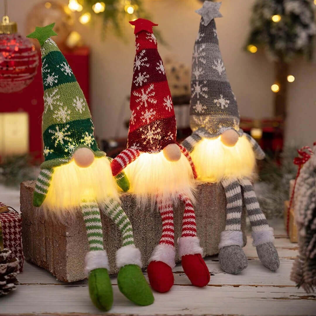 Three illuminated Christmas-themed gnomes