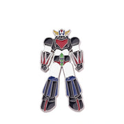 An enamel pin shaped like the Robotech M-102 Armageddon robot, featuring a white body with black, red, blue, green, and gold accents, set against a plain white background.