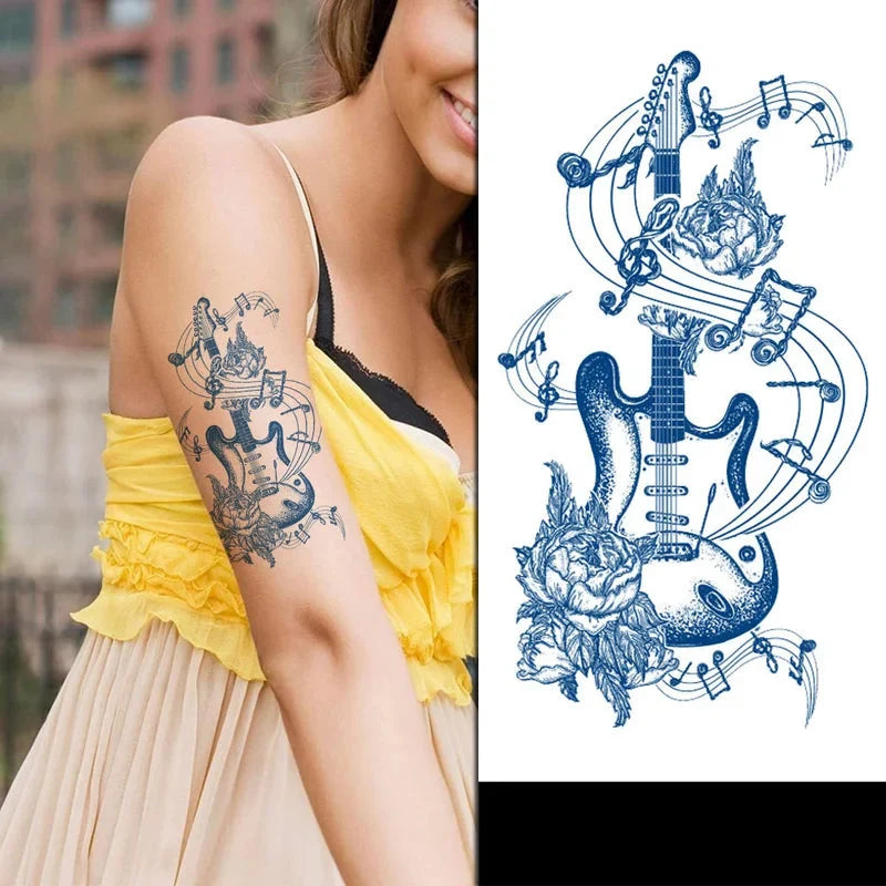 Woman with a guitar tattoo design on her arm, next to a detailed blue tattoo design of a guitar with music notes and flowers