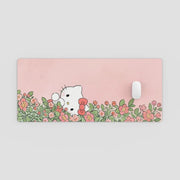 Pink mouse pad with cartoon character and floral design on a light gray background