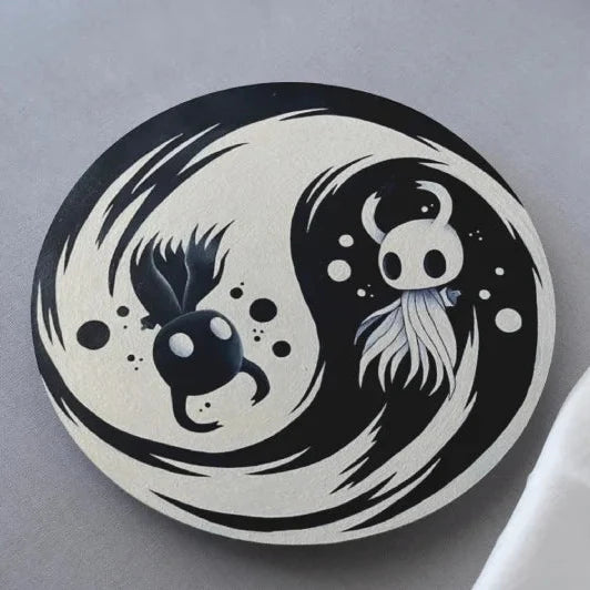 Yin and yang design with cartoon characters from hollow knight video game on a gray background