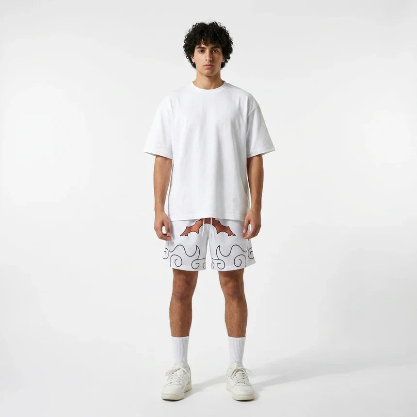 Person wearing a white t-shirt and shorts with a pattern on a plain background