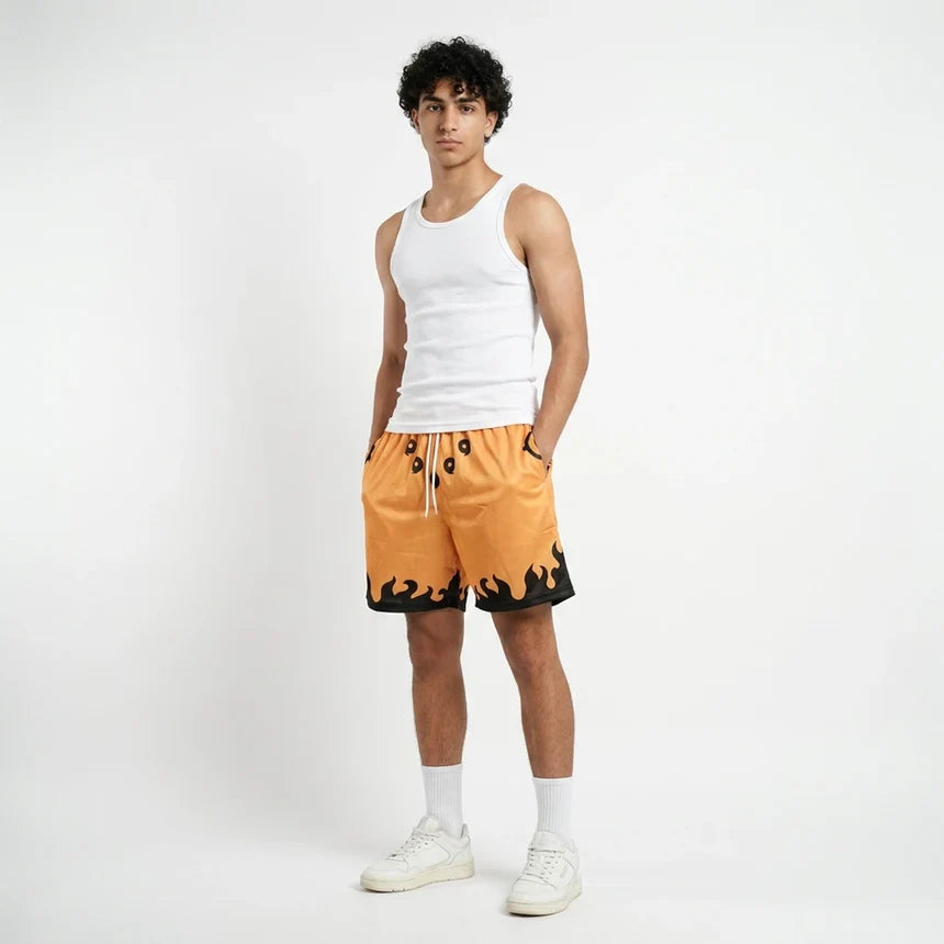 Person wearing a white tank top and orange shorts with black accents on a white background