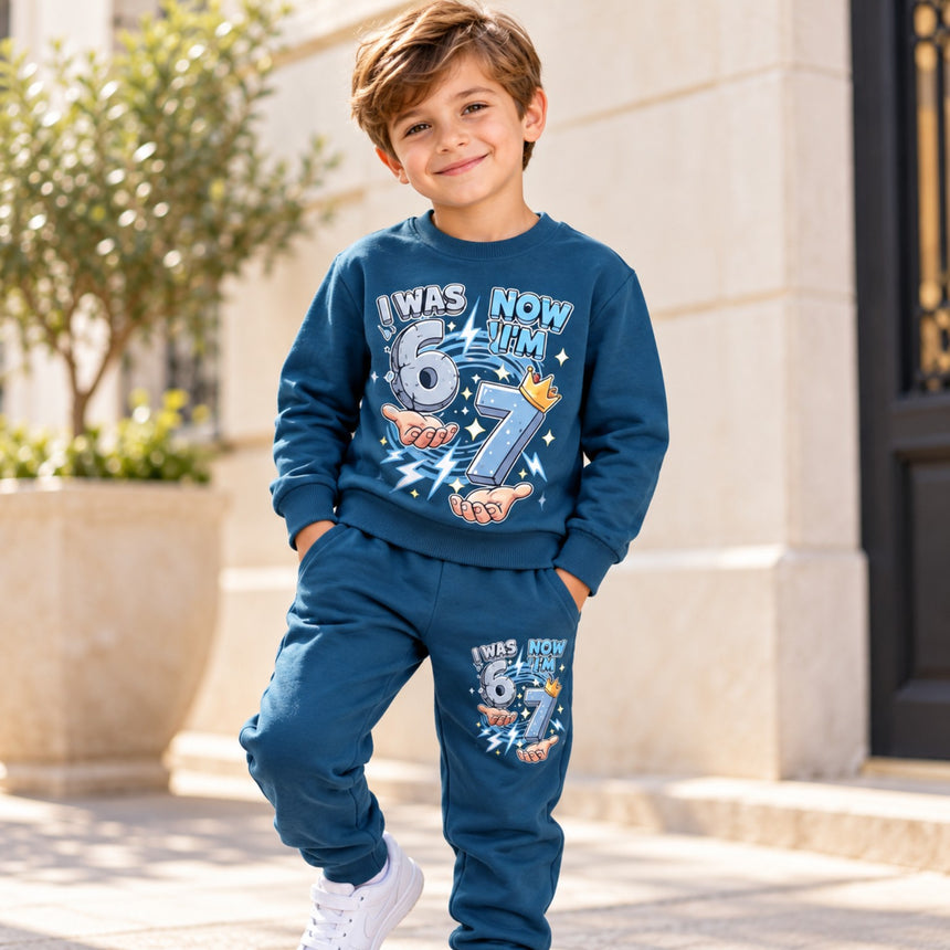 Front view of boys blue I Was 6 Now I'm 7 printed sweatshirt and matching jogger trousers