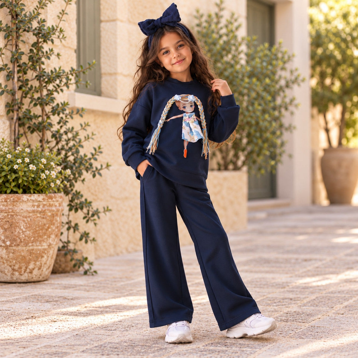 Full-length view of girls navy blue doll sweatshirt and matching wide-leg pants