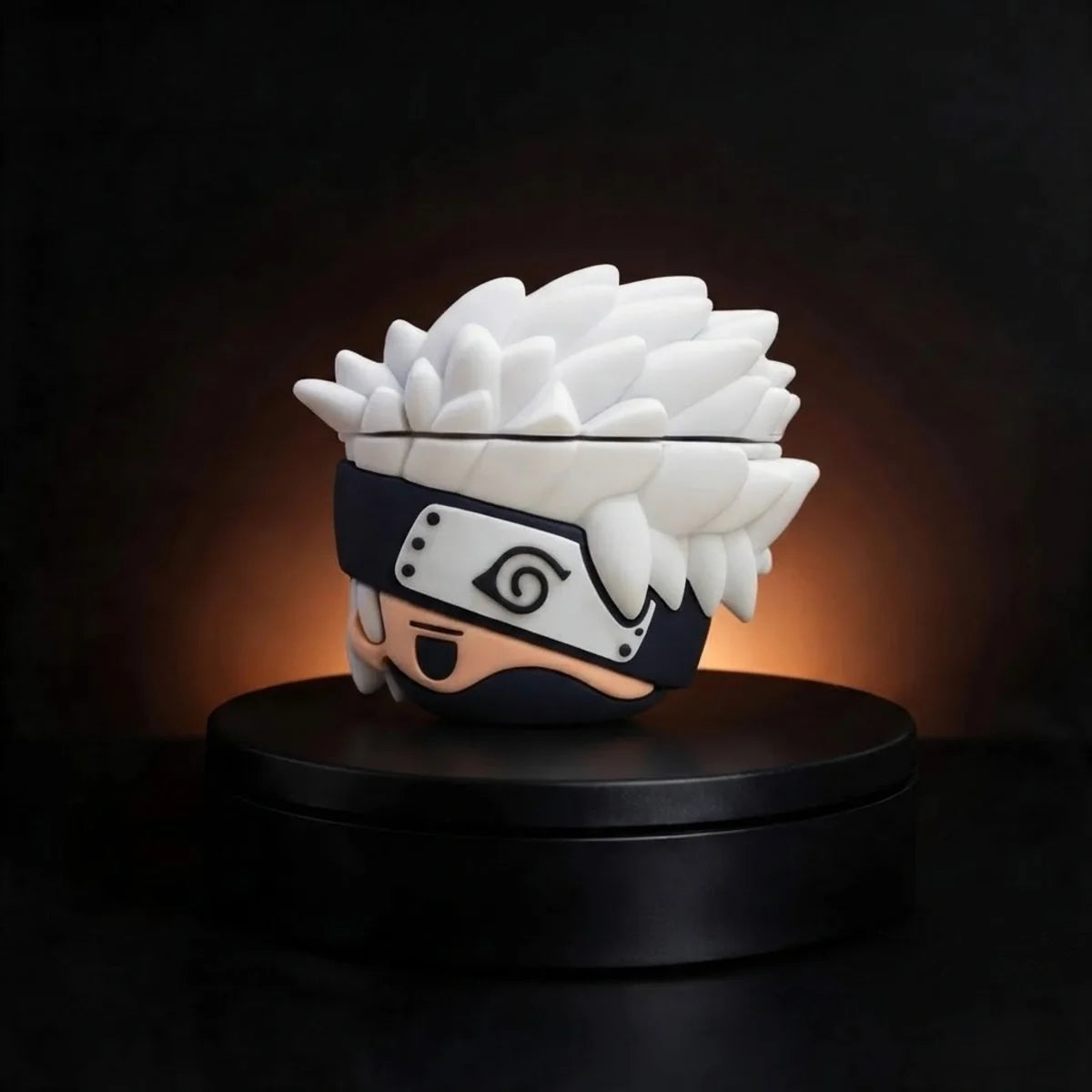 A Naruto character case for apple airpods spiky-haired ninja with a black headband and pale skin, displayed on a round black pedestal against a dark background with warm lighting.