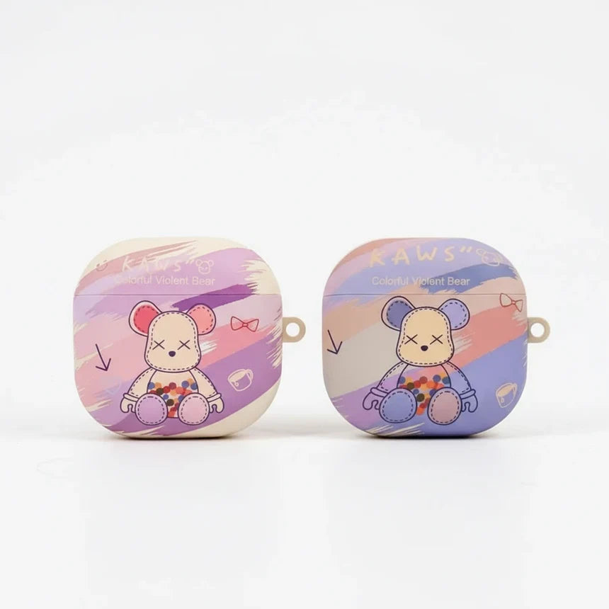 Two purple and pink galaxy buds  cases with cartoon bear designs on a white background